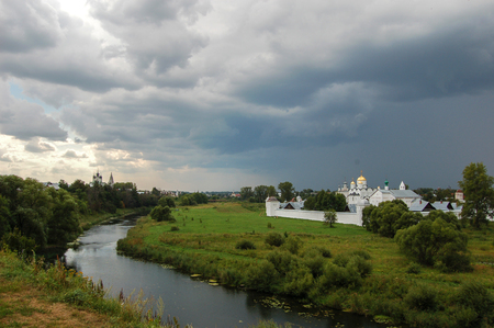The river surrounds the old monastery. There's a storm coming. Suzdal, Russiaの写真素材