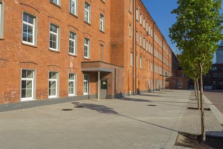 Office building of red brick in the yard of the old factoryの写真素材