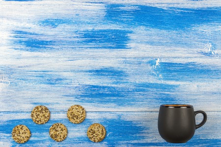 The Cup of tea on a blue background. Five cookiesの写真素材