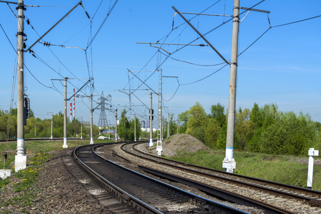 A sharp turn of the Railway. Three ways. Poles with electrical wire. Summerの写真素材