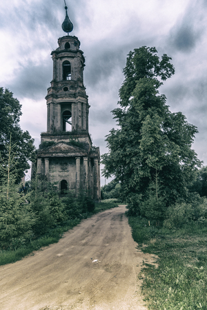 An old ruined Church on a forest road. Abandoned placeの写真素材