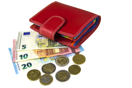 Isolate on white background. EU cash. Banknotes of 5, 10, 20 euros. Some coins. Woman's red walletの写真素材
