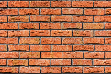 Red brick wall. Decorative brick with artificial defects and cracks. Backgroundの写真素材
