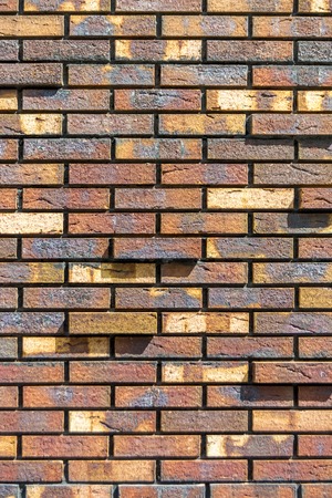 Red brick wall. Decorative brick with artificial defects and cracks. Background textureの写真素材