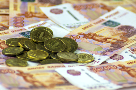 Russian cash close-up. Banknotes of 5000 rubles. Coins scattered.の写真素材