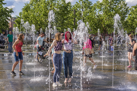 Moscow, Russia, 02 June 2019. Teenage girls playing in the fountain of the city Park.のeditorial素材