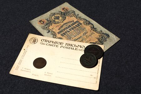 Moscow. Russia. 30 june 2019. Russian banknote 1909 5 rubles and an old postcard of the early 20th century.のeditorial素材