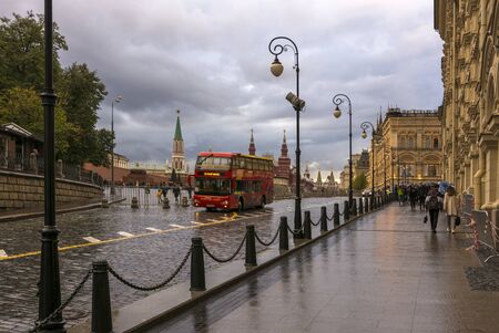 Moscow, Russia. September 18, 2019. Red square in the rain. A double-Decker bus and people with umbrellas.のeditorial素材
