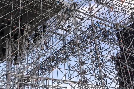 Erecting a stage for a concert. Installers on the scaffoldingの写真素材