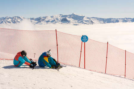 Rosa Peak, Russia, March 20, 2020. Snowboarders prepare for the race sitting on the track.のeditorial素材