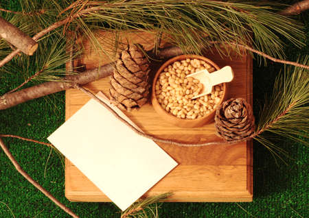 Peeled pine nuts in a bowl on a wooden standの写真素材