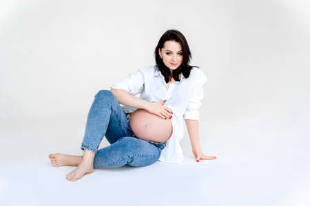 Portrait of the young pregnant woman wearing at casual style