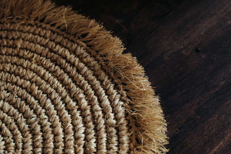 Straw braided beige eco-friendly spiral napkin, abstract background copy of the space. space for...