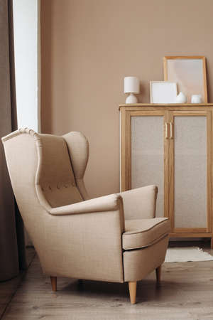 A luxurious cushioned window seat in a soft beige color in a light pastel interior.の写真素材