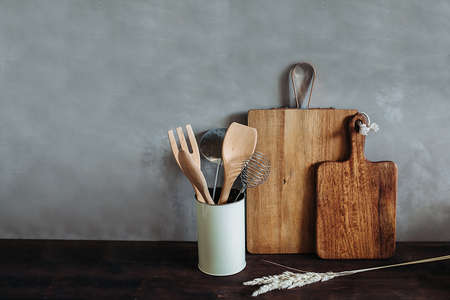 Kitchen appliances on a wooden table top, against a gray textured wall. Dry spikeletsの写真素材