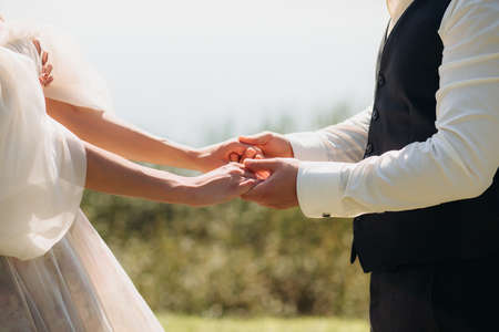 A couple in love holding hands, facing each other. Close up . On fresh air. open areaの写真素材