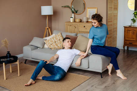 couple in home made clothes. sit on a warm wooden floor, spend time together with your beloved. A...