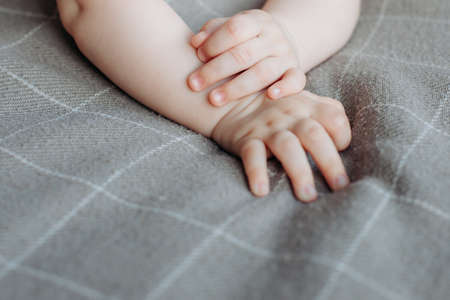 Child's hand . the child is lying on his stomach, hands, nails close-up . newborn .の写真素材