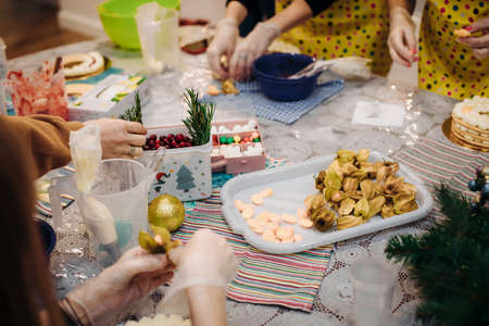 Christmas edible decorations ,for cake decoration. Hands of the pastry chef close-up.Christmas holiday atmosphere.の写真素材