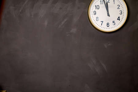 part of a white clock on a grey grunge background .
