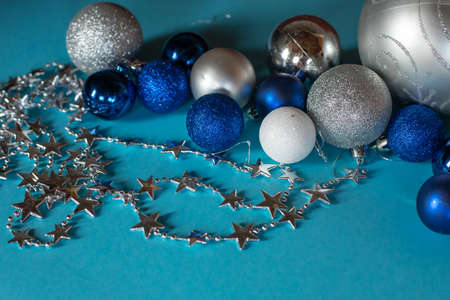 Christmas decorations.a garland of stars and Shiny Christmas balls of different sizes on a turquoise background.の写真素材