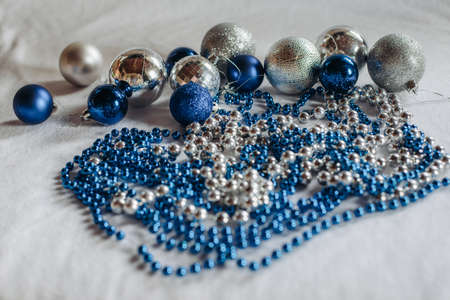 shiny and blue silver Christmas balloons and a garland on a white background with a space for text. Christmas and New year conceptの写真素材