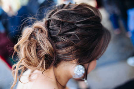 The beauty of a wedding hairstyle. Bride. A brunette brown-haired with curly hair.Hair decoration....