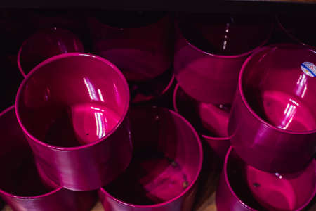 empty, clay colorful empty flower pots stand on a shelf in the storeの写真素材