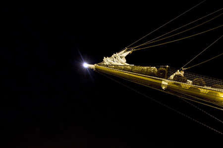 Night view of a bowsprit of a sailing ship wooden overlap with the moon in the backgroundの写真素材
