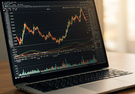 Laptop with stock market data on screen. Financial and trading conceptの素材