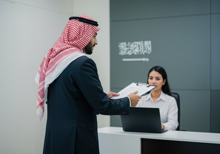 Arabic Businessman and Businesswoman Working with Laptop in Officeの素材