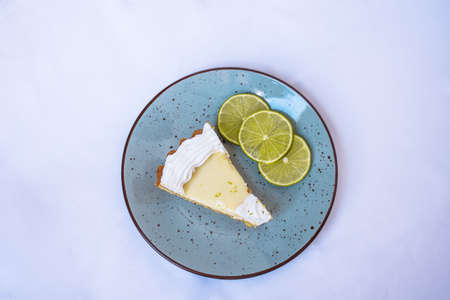 Lemon Pie on a blue plate with lemon slices and white backgroundの写真素材