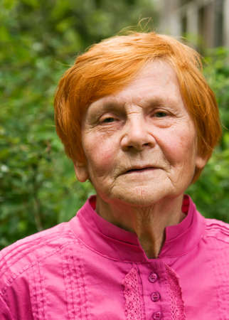 portrait of old senior woman with gentle smileの写真素材