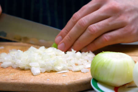 closeup pieces of onion, cutted with knifeの写真素材