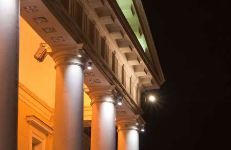 a part of an old building with columns, it is illuminated in the nightの写真素材