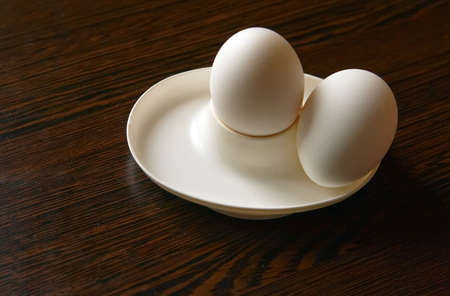 breakfast of two boiled eggs in a white eggcup