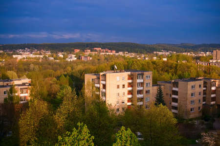 view of an urban residential district in Europe before thunderstorm - sun is still shining, but the sky is very contrast and darkの写真素材