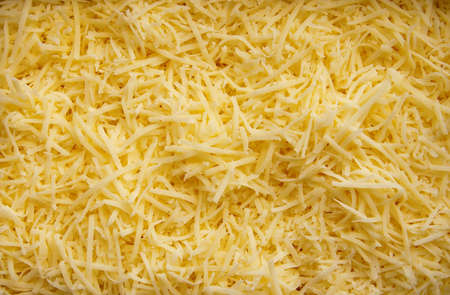 close-up background made of shredded yellow cheese, tasty and freshの写真素材