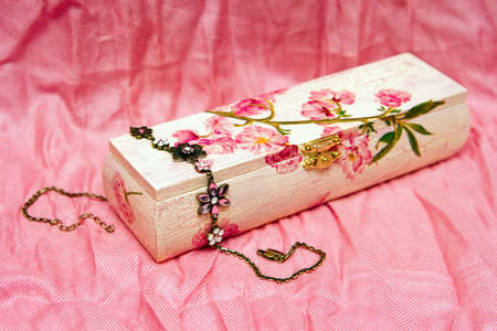 pink decoupage box with painted flowers and a bijouterieの写真素材
