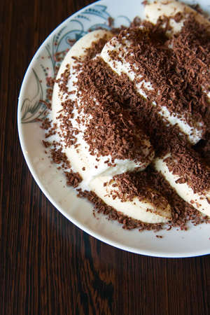 close-up cut bananas with vanilla ice-cream crumbled up with chocolateの写真素材