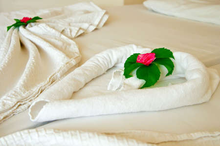 close-up decoration on a hotel room's bed with flowersの写真素材