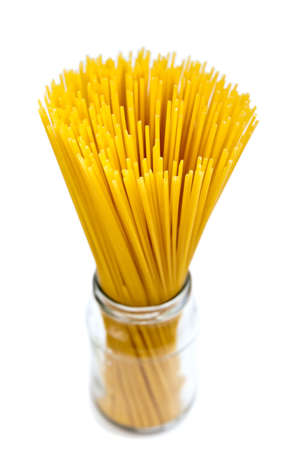 close-up bunch of raw pasta in a bottle, isolated on white backgroundの写真素材