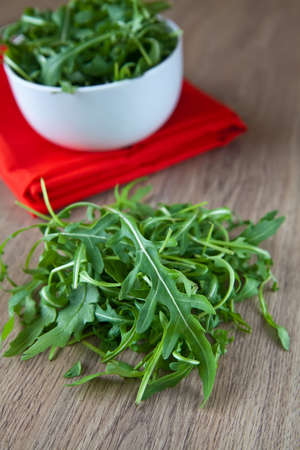 close-up heap of green ruccola on a tableの写真素材