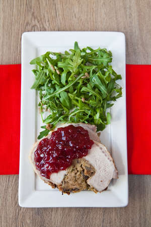 meat baked with mushrooms under cowberry jam, served with ruccolaの写真素材