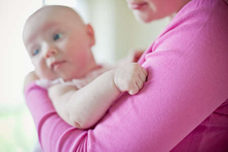 close-up little fist of a baby girl, the rest of the photo is out of focus