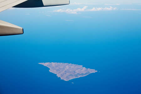 Boeing 737 wing flyingd above Greek islandの写真素材