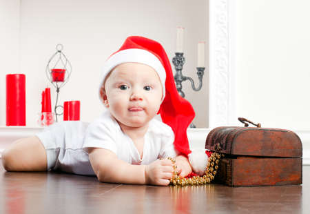 close-up portrait of a little lying boy in christmas capの写真素材