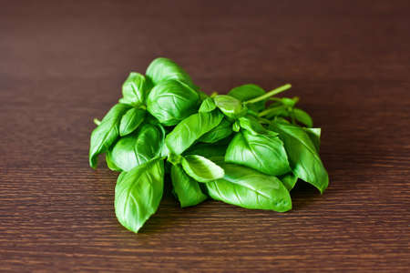 close-up heap of green basil on a tableの写真素材