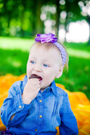 little girl eating a candy - sweet mushroom