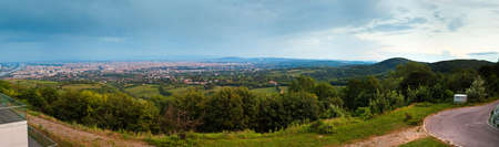 panoramic view of some districts of Vienna in the evening, from the hill in suburb of the cityの写真素材
